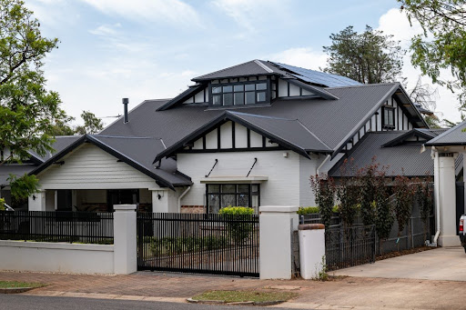 Modern heritage-style home with dark night sky COLORBOND® roof and gutter colour combo, paired with black fascia and white exterior walls featuring black trim accents